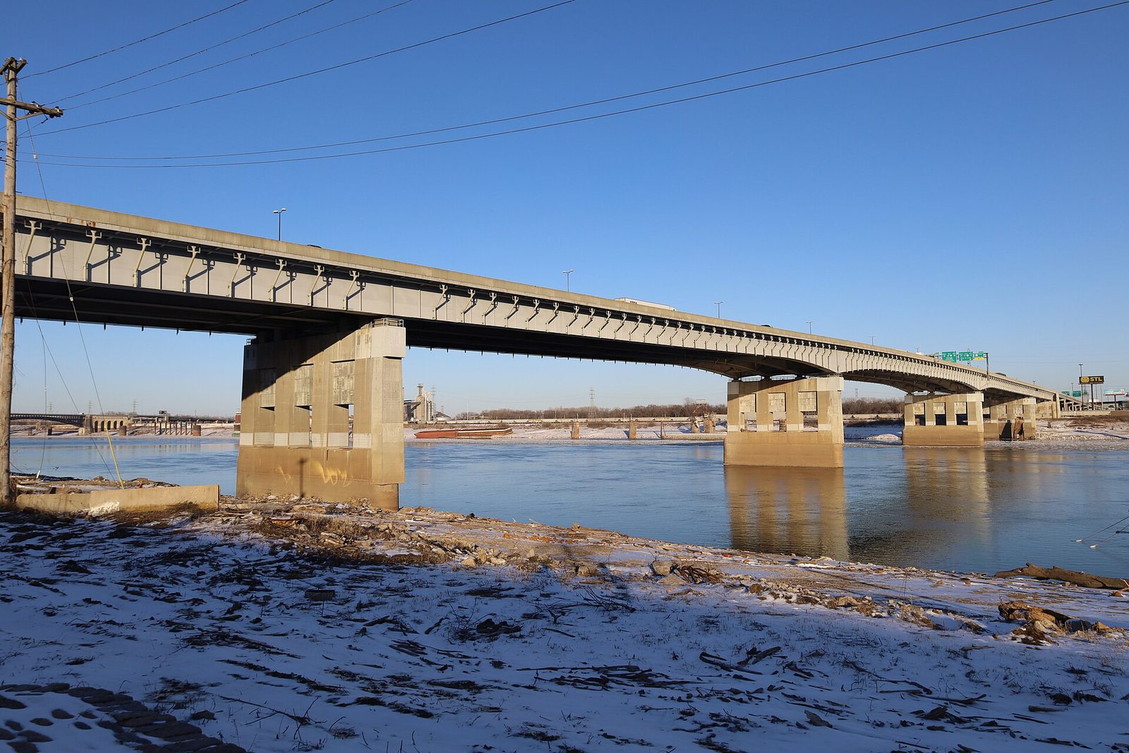 The Poplar Street Bridge carrying interstate traffic across the Mississippi River at St. Louis, seen from the riverbank